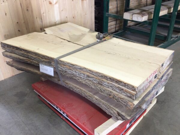 wood slabs neatly organized on top of a red pallet