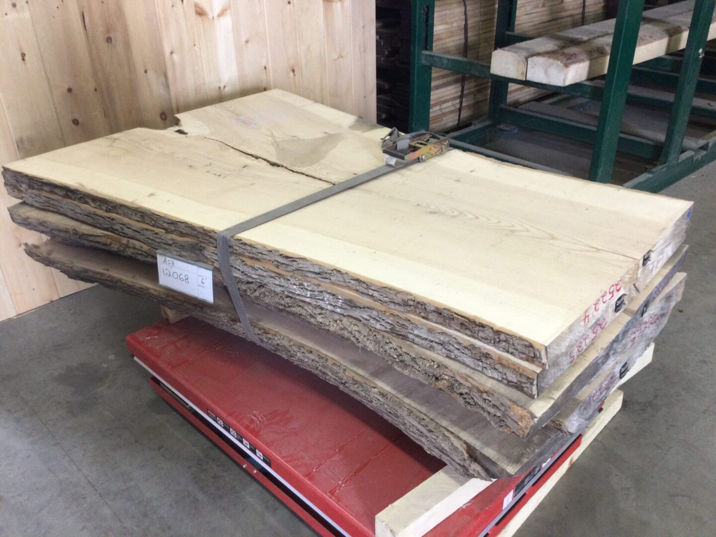 wood slabs neatly organized on top of a red pallet