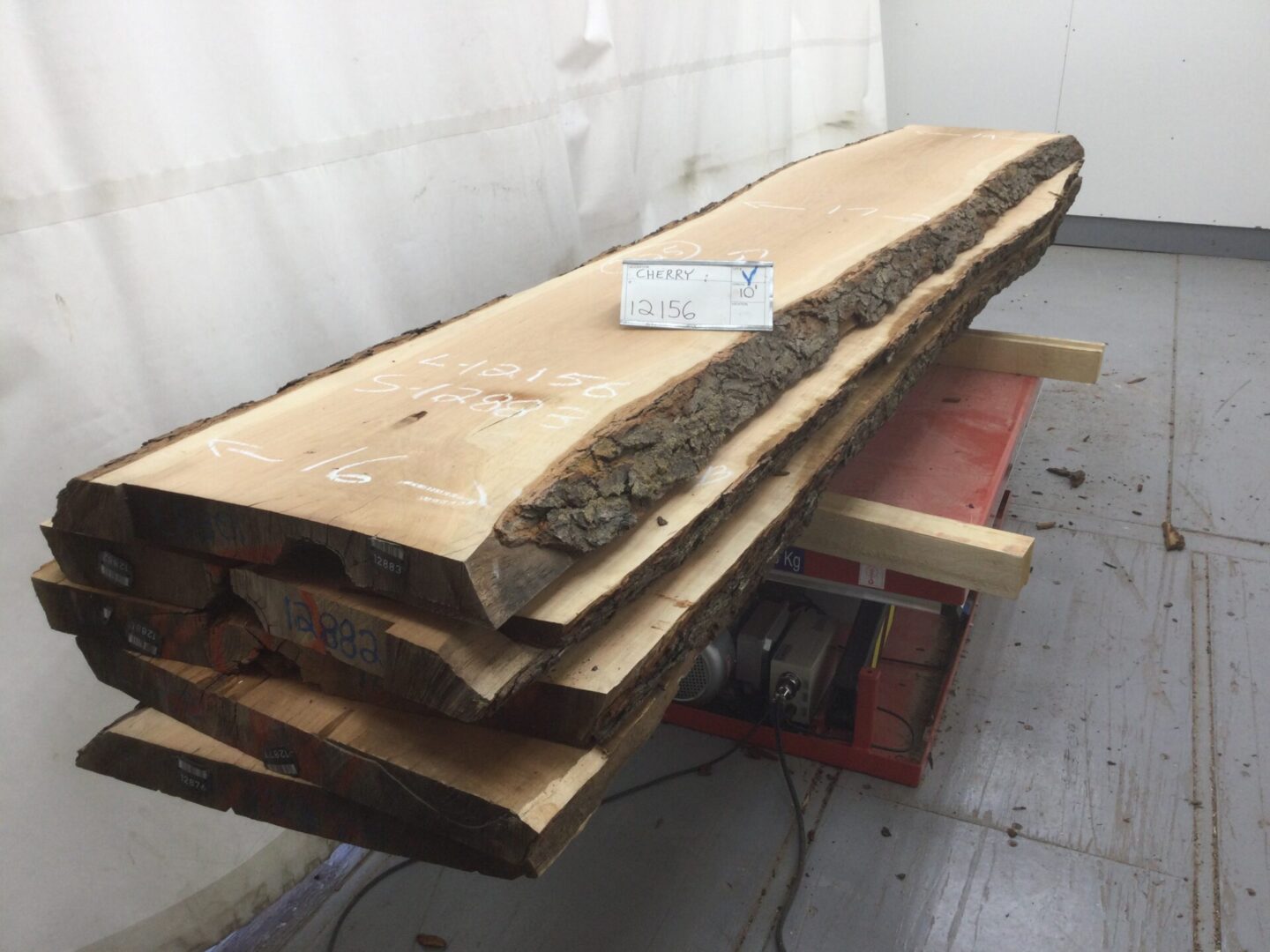 wooden cherry slabs on red stand 12156