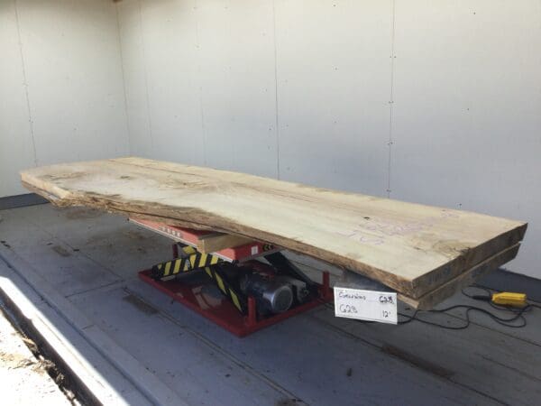 large thin slab of wood onto mechanical red stand