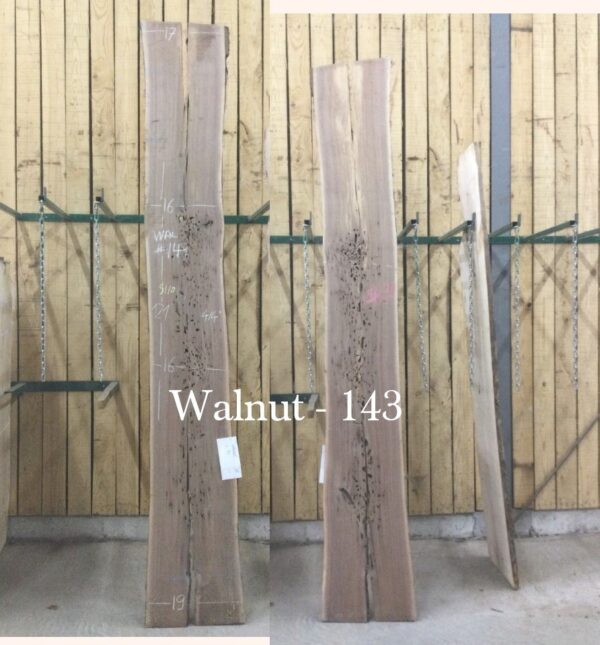 two large wooden slabs on wooden stands white text Walnut 143