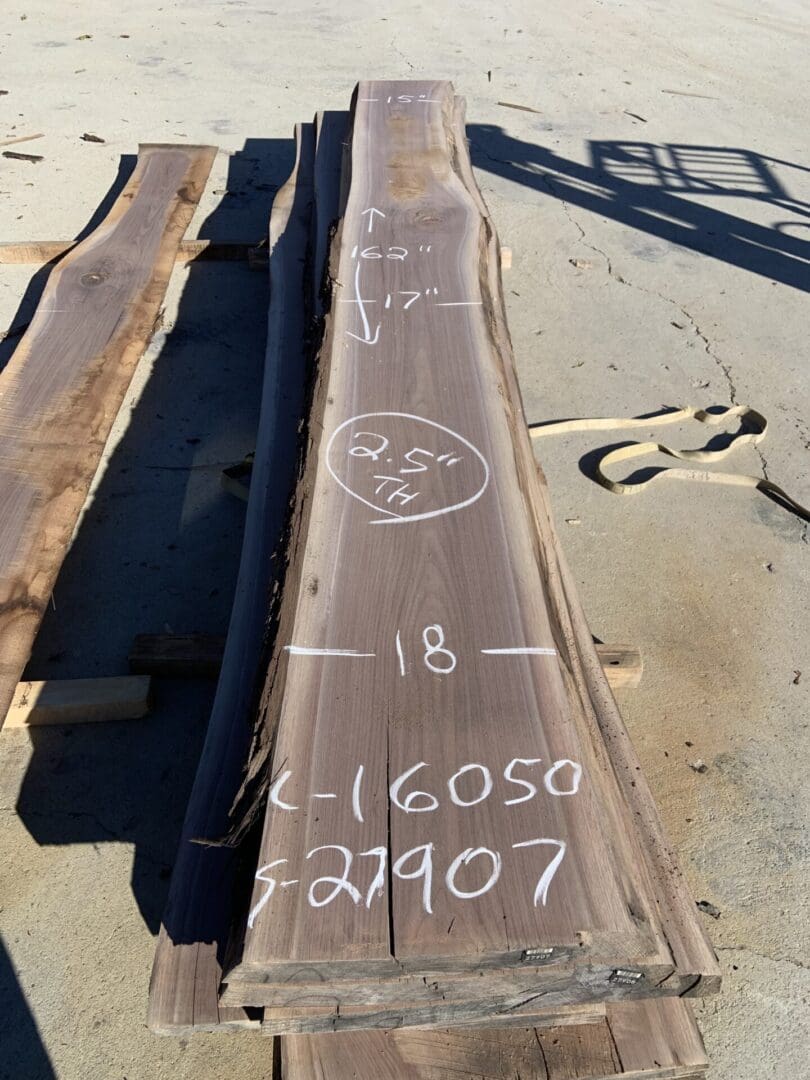 Rusty metal beams with handwritten markings on them.