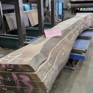Stack of rough-cut wood slabs in mill