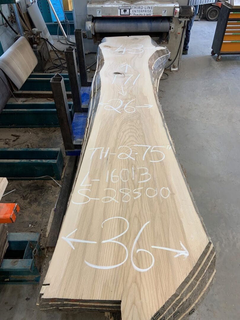 Live-edge wood slab with chalk measurements