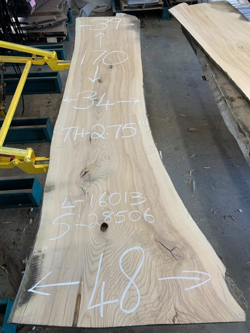 Live-edge wood slab with chalk measurements