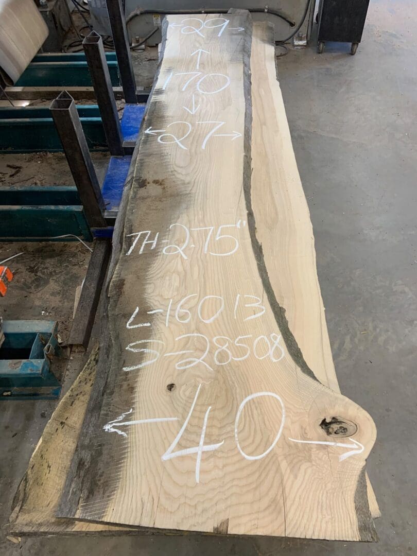 Live-edge wood slab with chalk measurements